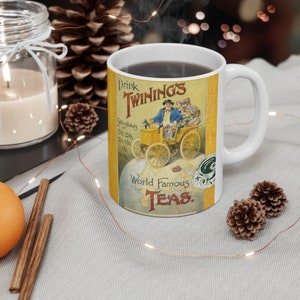 May include: White ceramic mug featuring a vintage advertisement for Twinings tea. The design includes a man in a yellow car, the text "Drink Twinings", and "World Famous Teas". The mug is filled with a dark liquid.