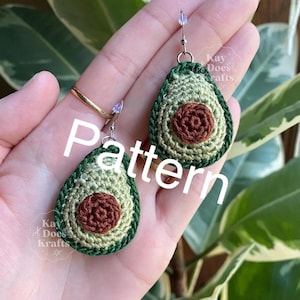 May include: Crocheted avocado earrings with a green and brown color scheme. The earrings are in the shape of an avocado, with a brown seed in the center. The word "pattern" is written across the image.