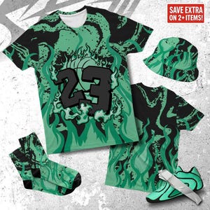 以下が含まれることがあります： 緑と黒の炎模様が特徴的なお揃いの服のコレクション。23番とバスケットボールのグラフィックが入ったTシャツ、バケットハット、靴下、スニーカーが含まれています。「SAVE EXTRA ON 2+ ITEMS!」というテキストが表示されています。