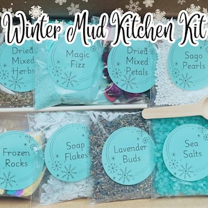 May include: A Winter Mud Kitchen Kit with various ingredients in clear bags, including dried herbs, magic fizz, dried mixed petals, sago pearls, frozen rocks, soap flakes, lavender buds, and sea salts. A wooden spoon is included.