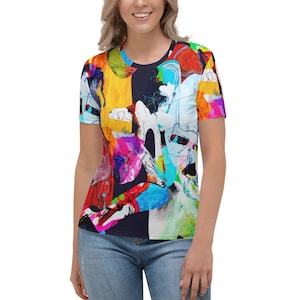 May include: A women's t-shirt featuring a colourful abstract design with bright colours such as red, yellow, blue, green, and pink. The design is a mix of geometric shapes and organic lines.