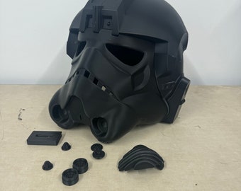 May include: A black plastic Star Wars Stormtrooper helmet with various parts disassembled around it. The helmet is a replica of the helmet worn by the Stormtroopers in the Star Wars movies.