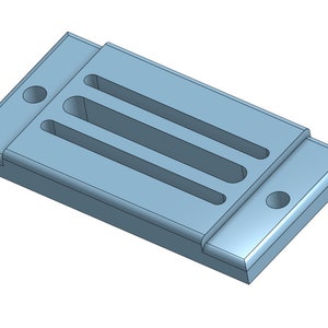 May include: A light blue plastic rectangular object with three long, narrow slots and two round holes. The object is designed to hold small items.