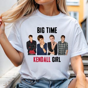 May include: White t-shirt with a black and red graphic of the band Big Time Rush. The graphic includes the band members' names and the text "BIG TIME" and "KENDALL GIRL".