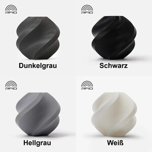 May include: Four ceramic vases in different colors: dark gray, black, light gray, and white. Each vase has a unique twisted design.