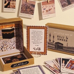 May include: A brown box with a gold lid and a small white card with text that reads "Then depart from the place from where all the people depart and ask for forgiveness of Allah. Indeed, Allah is forgiving and merciful. 2:199". The box is labeled "My Little Box of Hajj & Umrah". The box contains a set of small cards with images and text about the Hajj and Umrah pilgrimages.