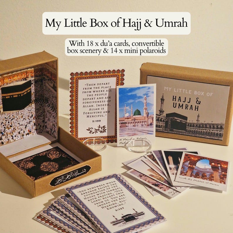 May include: A brown box with a lid open, revealing a miniature scene of the Kaaba in Mecca. The box includes 18 dua cards, 14 mini polaroids, and a convertible box scenery. The text on the box reads "My Little Box of Hajj & Umrah".