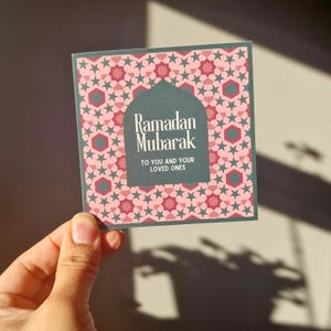 Pack of 8 mini Ramadan Eid cards with Islamic geometric designs, in a maroon (red), pink and green colourway. Each mini card measures 10 x 10cm each, and comes with a white envelope. Perfect for gift giving during Ramadan and Eid.