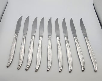 May include: Set of ten silver dinner knives with a floral design on the handle.