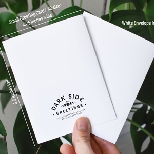 May include: A white greeting card with a white envelope. The card is 4.25 inches wide and 5.5 inches tall. The card has the text "DARK SIDE GREETINGS" and the website address. The envelope is included.