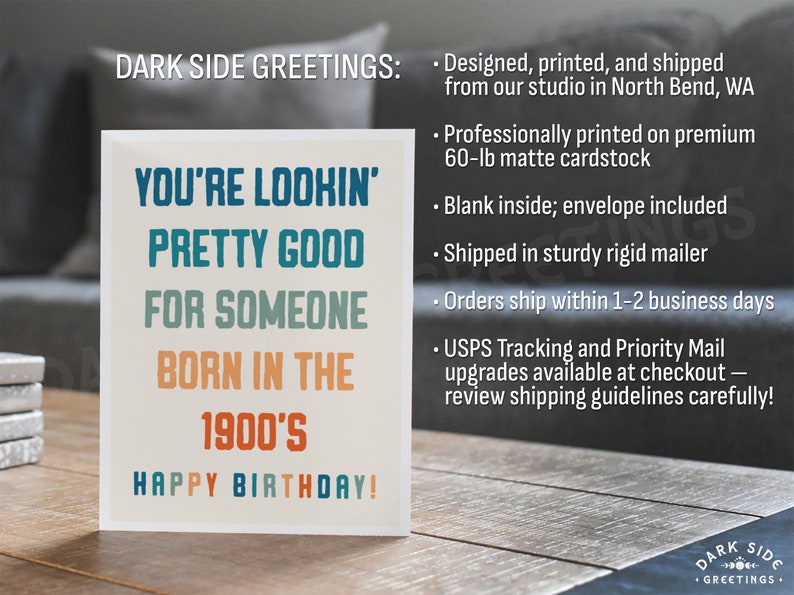 May include: A birthday greeting card with the text "YOU'RE LOOKIN' PRETTY GOOD FOR SOMEONE BORN IN THE 1900'S HAPPY BIRTHDAY!" in blue, teal, and orange. The card is on a wooden surface.