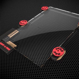 May include: A clear rectangular acrylic sheet held by four red circular knobs and a black corner bracket labeled GRPT-S PRO. The red knobs are also marked with the text GRPT PRO. The assembly features a transparent panel with a grid pattern.
