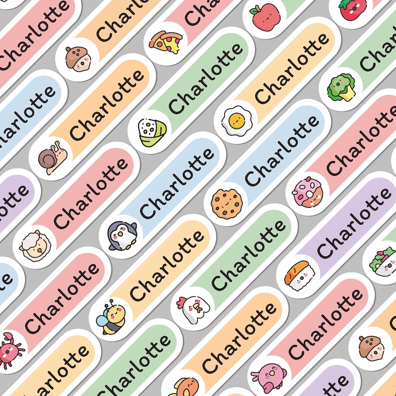 May include: A collection of colorful name labels with the name "Charlotte" printed on them. Each label features a different cartoon illustration, including an apple, pizza slice, cookie, and penguin. The labels are arranged diagonally on a gray background.