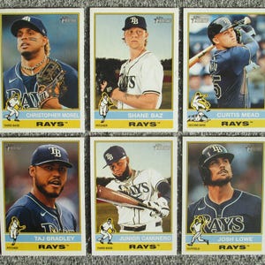 May include: Six baseball trading cards featuring Tampa Bay Rays players. Each card has a player's image, name, and position. The cards have a vintage design with the team logo and the word "RAYS".
