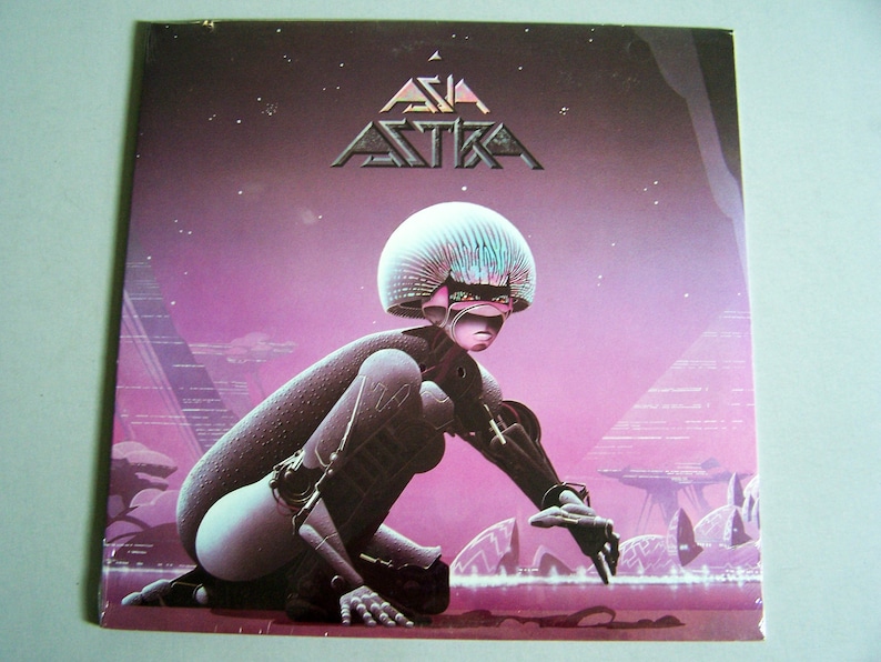 May include: Album cover for "Asia Astra" featuring a futuristic figure in a purple and pink landscape. The album title is at the top in a stylized font. The artwork has a science fiction theme with a retro aesthetic.