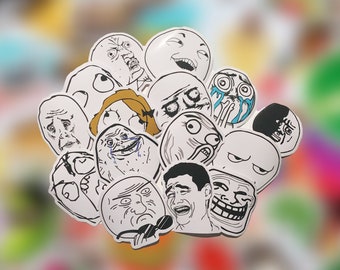 May include: A collection of 14 different internet meme faces printed on white stickers. The stickers feature various expressions, including surprised, confused, and laughing.