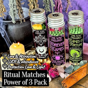May include: Three glass vials of ritual matches with silver lids. Each vial has a different label: "Ritual Matches," "Forever Flames," and "Flames of Fortune." The vials are filled with colorful elements. Text on the image reads "Ritual Matches Power of 3 Pack."