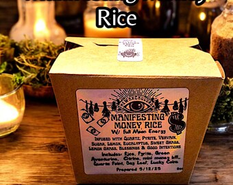 May include: A brown box labeled "Manifesting Money Rice" with text and illustrations. The label includes ingredients like quartz, pyrite, and lemon grass. The text "By: The Wax Cauldron" is at the bottom.