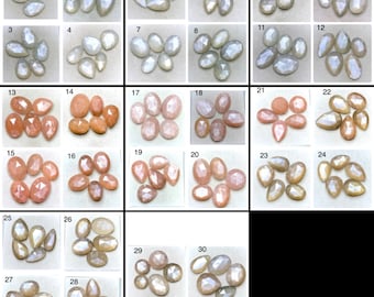 May include: A collection of thirty numbered groups of faceted gemstones in various shapes including pear, oval, and round. The stones display a range of translucent colours, including white, peach, tan, and grey, each featuring a polished surface.