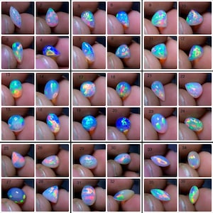 Peut inclure: Une collection de 36 opales, chacune avec des couleurs et des motifs uniques. Les opales varient en forme, y compris en forme de goutte, ovale et ronde. Les opales affichent une gamme de couleurs, notamment le bleu, le vert, le rose et l'orange. Les opales sont présentées sur un fond neutre.