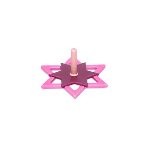 May include: A pink and purple wooden dreidel with a six-pointed star design. The dreidel is a traditional Jewish toy used during Hanukkah.