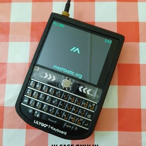 May include: Black plastic case for a Lilygo T-Keyboard with a small antenna. The case has a screen that displays "EU_868", "2.3.3", and "meshtastic.org". The text "!!! CASE ONLY !!! - NO ELECTRONIC/ANTENNA INCLUDED!!" is printed below the case.