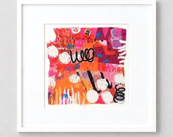 May include: A square framed art piece featuring a vibrant abstract collage with layers of bright orange, pink, and red paint. The composition includes bold black hand-drawn scribbles, white textured circular shapes, and small blue markings.