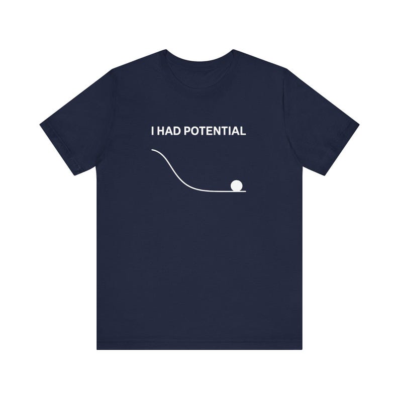 May include: Navy blue t-shirt with the text "I HAD POTENTIAL" above a white line drawing of a ball rolling down a slope. The shirt is a solid color and has short sleeves.