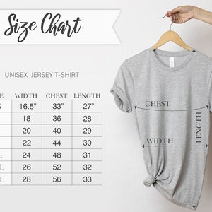 May include: A light gray unisex jersey t-shirt hanging on a wooden hanger. The image includes a size chart with measurements in inches for width, chest, and length, ranging from XS to 3XL. The text "Size Chart" is at the top.
