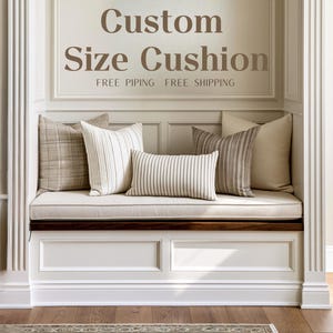 May include: A collection of five decorative cushions in neutral tones, including plaid, striped, and solid patterns, arranged on a bench. The text Custom Size Cushion is displayed above. The cushions feature various textures and fabric designs.