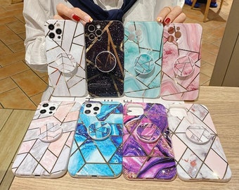May include: Seven different phone cases with a marble and geometric design. Each case has a pop socket attached to the back.