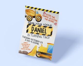 May include: A yellow and black construction themed birthday invitation for a boy named Daniel turning two. The invitation features a yellow cement mixer truck and a yellow bulldozer. The text reads "Stop the traffic & close the road! Grab your tools! Daniel is turning two! Tuesday October 25 2:00-4:00PM Thomas's Construction Site 281 Smith Ave. Boston MA RSVP-561-336-8266"