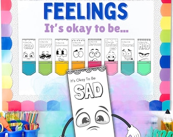 May include: A classroom bulletin board with the title "Feelings: It's okay to be..." and colorful cards with different emotions, including sad, happy, confused, nervous, excited, scared, and mad. Each card features a cartoon face and the word "It's okay to be..." followed by the emotion.