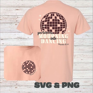 May include: A peach-colored t-shirt with a brown disco ball graphic and the text "You turn my mourning into dancing Proverbs 30:19" on the back. The front of the shirt has a smaller disco ball graphic with the text "Proverbs 30:19".
