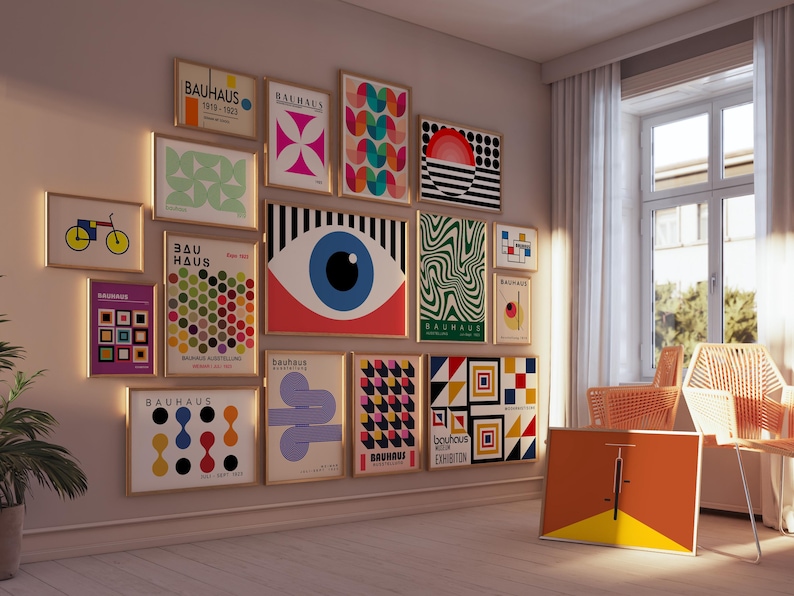 May include: A wall gallery featuring 14 framed prints with geometric designs and the text "Bauhaus" in various colors and fonts. The prints are arranged in a grid pattern and include abstract shapes, circles, and lines.