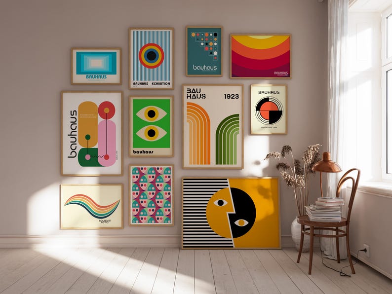 May include: A wall gallery featuring nine framed prints with geometric designs in various colors, including yellow, orange, red, green, blue, and black. The prints feature the text "Bauhaus" and "Bauhaus Exhibition".