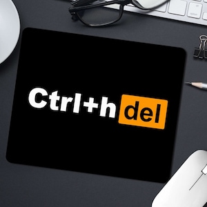 May include: Black mouse mat with the text "Ctrl+hdel" in white letters and a bright orange rectangle with the word "del" in white letters.