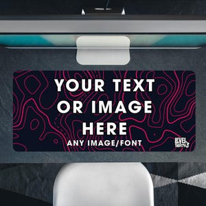 May include: A rectangular desk mat with a dark blue background and a pink topographic pattern. The mat features the text "YOUR TEXT OR IMAGE HERE" in white, with "ANY IMAGE/FONT" below. The Level Thirty3 logo is in the bottom right.