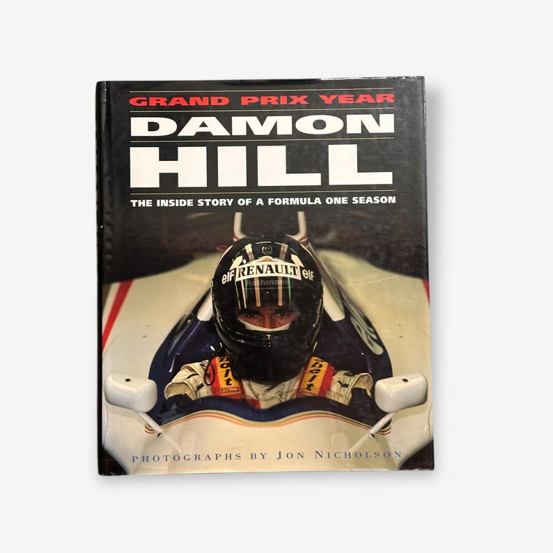 May include: A book cover featuring a photo of Damon Hill in a Formula One race car. The title is "Grand Prix Year Damon Hill: The Inside Story of a Formula One Season".