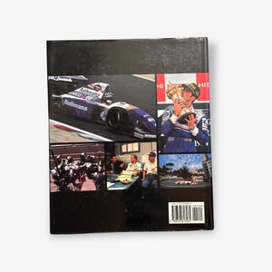 May include: The back cover of a book about Formula One racing. The cover features a photo of a Formula One race car, a photo of a driver holding a trophy, and a photo of a group of people. The book title is "Hit the Road Jack".