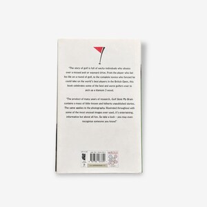 May include: A book cover with text and a red and white golf flag graphic. The text describes the story of golf and the best and worst golfers. The book is titled "Golf Stole My Brain".