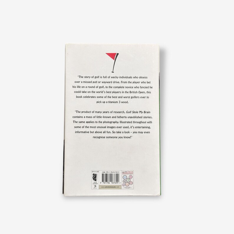 May include: A book cover with text and a red and white golf flag graphic. The text describes the story of golf and the best and worst golfers. The book is titled "Golf Stole My Brain".