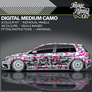 May include: A silver hatchback car with a digital camouflage design in pink, gray, and black. The text "DIGITAL MEDIUM CAMO" is displayed above the car, along with other details. The car has custom wheels.