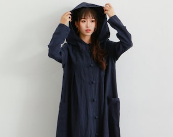 May include: A long, navy blue hooded dress with a button-up front and two pockets. The dress is made of a soft, textured fabric.