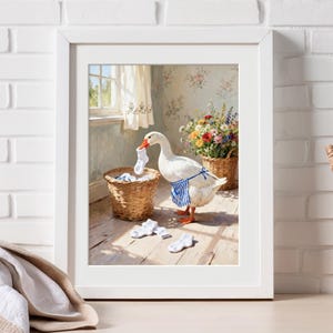 May include: Framed art print featuring a goose wearing a blue and white striped apron, holding a sock, and sorting laundry. The artwork has a vintage aesthetic, with a basket of socks and flowers in the background.