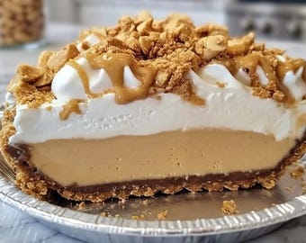 May include: A slice of peanut butter pie in a silver pie tin. The pie has a chocolate crust, a peanut butter filling, a layer of whipped cream, and is topped with peanut butter drizzle and peanut brittle.