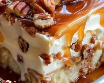 May include: A layered dessert featuring a light-colored sponge cake base topped with a thick layer of white cream, drizzled with amber-colored caramel sauce, and garnished with numerous chopped brown pecans throughout the top and sides.