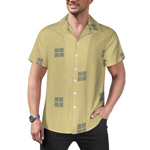 May include: A yellow short-sleeved button-down shirt with a geometric pattern. The shirt has a collared neckline and a button closure.