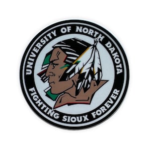 May include: A black and white circular logo with the text "University of North Dakota Fighting Sioux Forever". The logo features a Native American man in profile wearing a headdress with feathers.