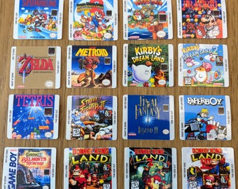 May include: A collection of sixteen square Nintendo Game Boy game labels featuring various titles including Super Mario Land, The Legend of Zelda, Metroid, Kirby's Dream Land, Tetris, Street Fighter II, Final Fantasy Legend II, Paperboy, and Donkey Kong Land.